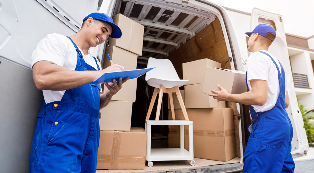 Sem Parar Empresas: Dois entregadores retirando caixas de uma van que pertence à transportadora de encomendas contratada